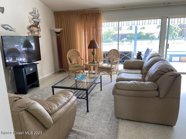 146 Bimini Road Cocoa Beach, FL 32931 - Photo 3 of 37 a living room with furniture and a large window