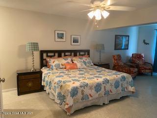 146 Bimini Road Cocoa Beach, FL 32931 - Photo 9 of 37 a bedroom with a bed and a chandelier