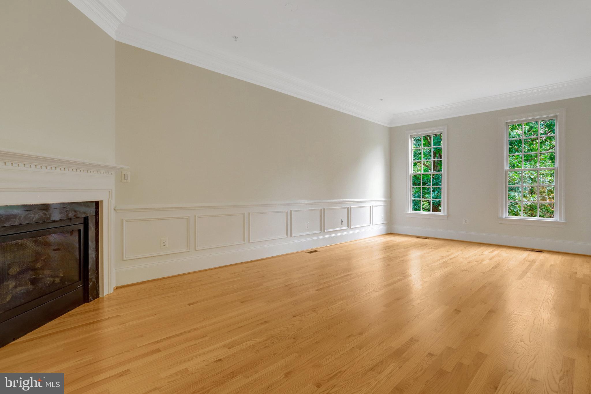 1852 Carpenter Road Alexandria, VA 22314 - Photo 21 of 63 an empty room with wooden floor fireplace and windows
