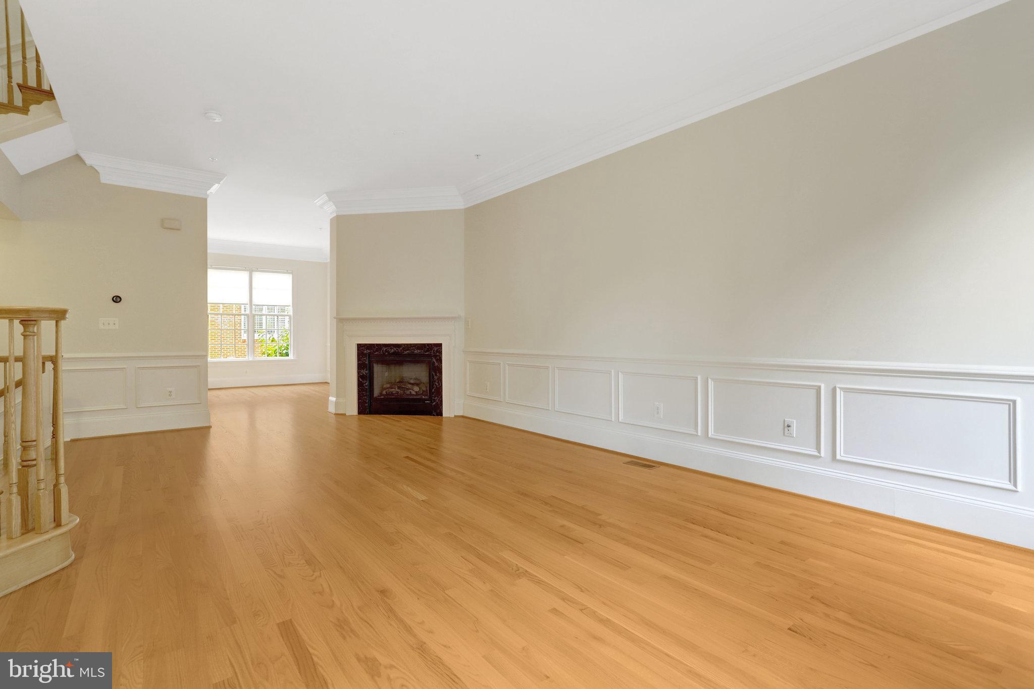 1852 Carpenter Road Alexandria, VA 22314 - Photo 24 of 63 a view of empty room with wooden floor and fireplace