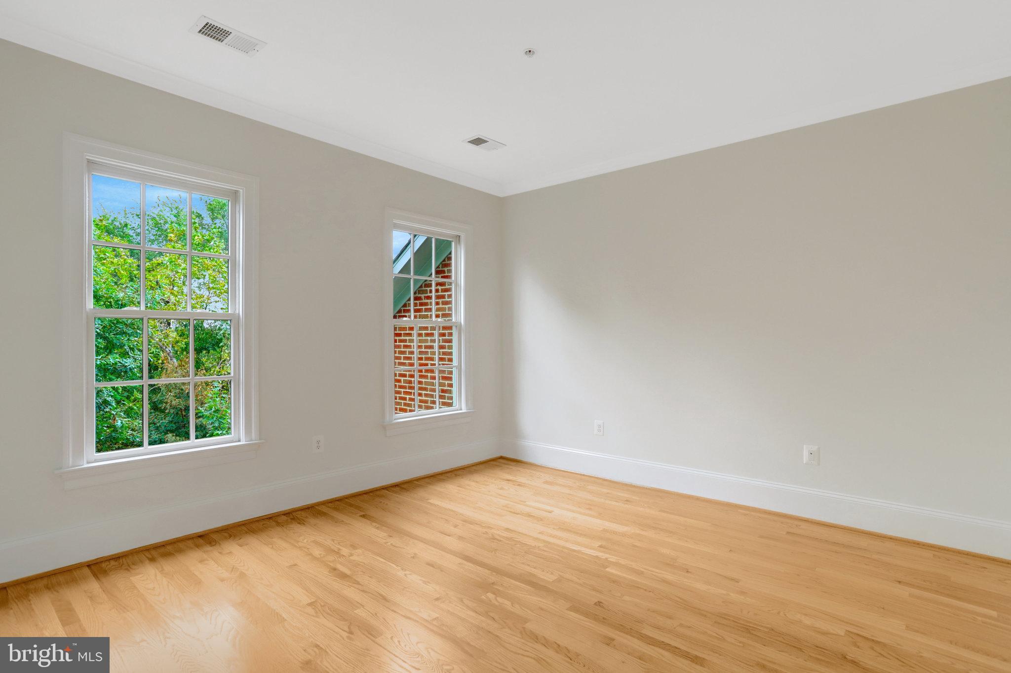 1852 Carpenter Road Alexandria, VA 22314 - Photo 29 of 63 a view of an empty room with wooden floor and a window