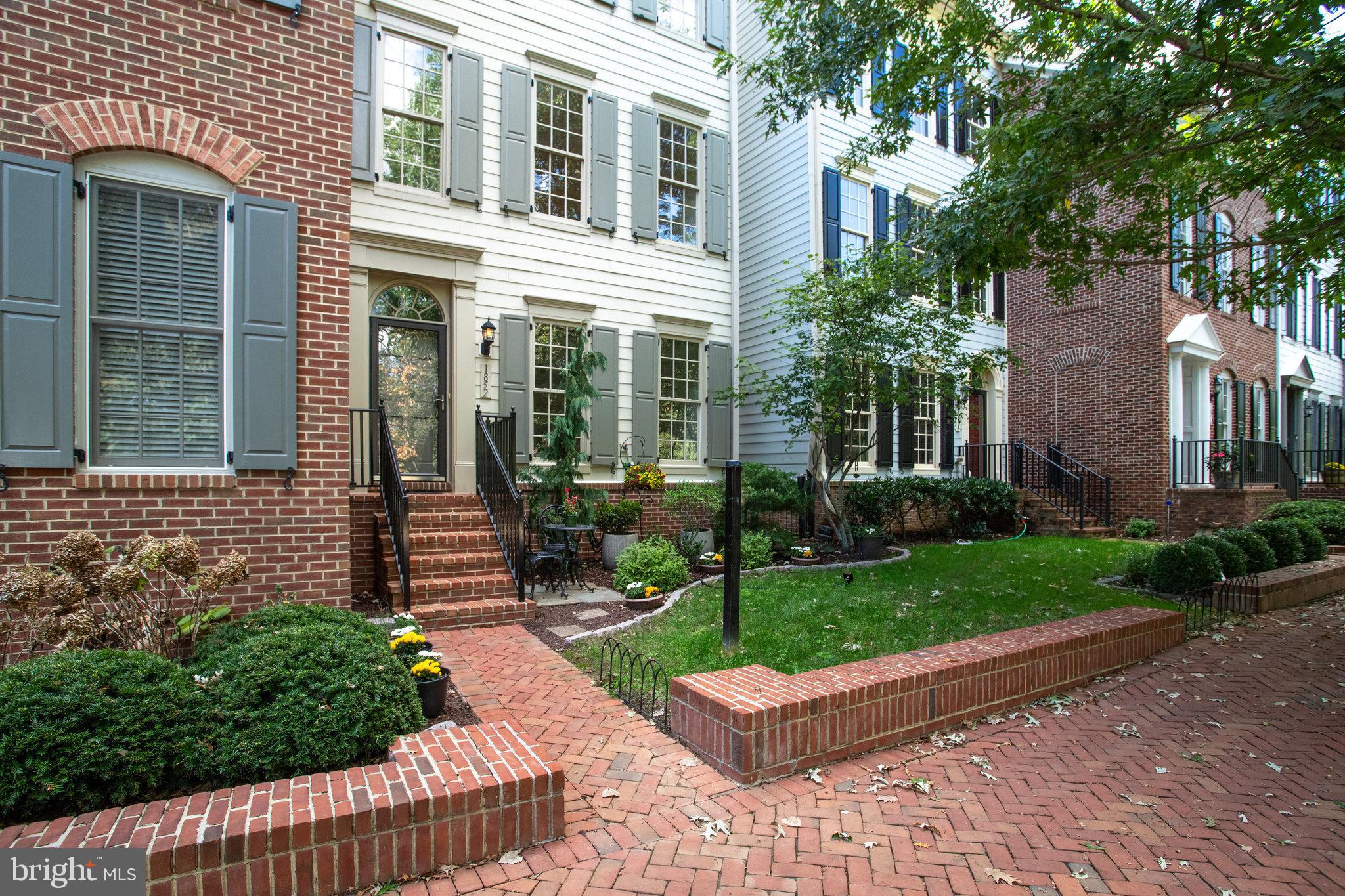 1852 Carpenter Road Alexandria, VA 22314 - Photo 3 of 63 a front view of a house with a garden and plants