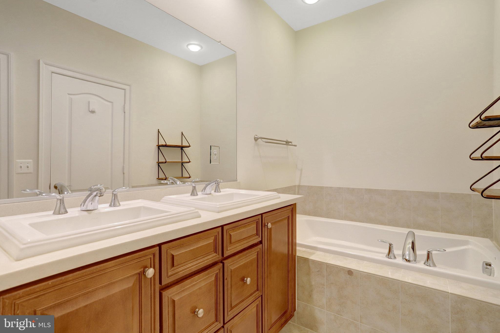 1852 Carpenter Road Alexandria, VA 22314 - Photo 34 of 63 a bathroom with a granite countertop sink and a bathtub