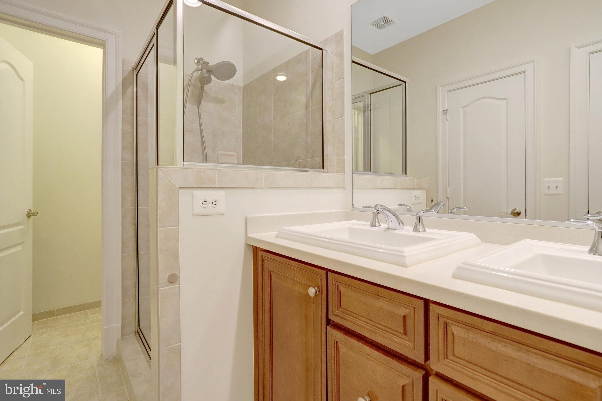 1852 Carpenter Road Alexandria, VA 22314 - Photo 35 of 63 a bathroom with a granite countertop sink and a mirror