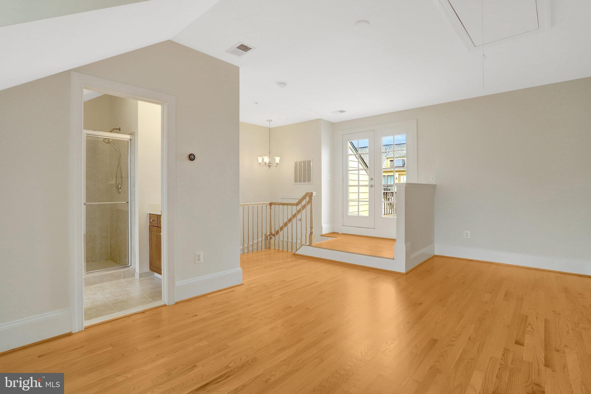 1852 Carpenter Road Alexandria, VA 22314 - Photo 49 of 63 a view of an empty room with window and wooden floor