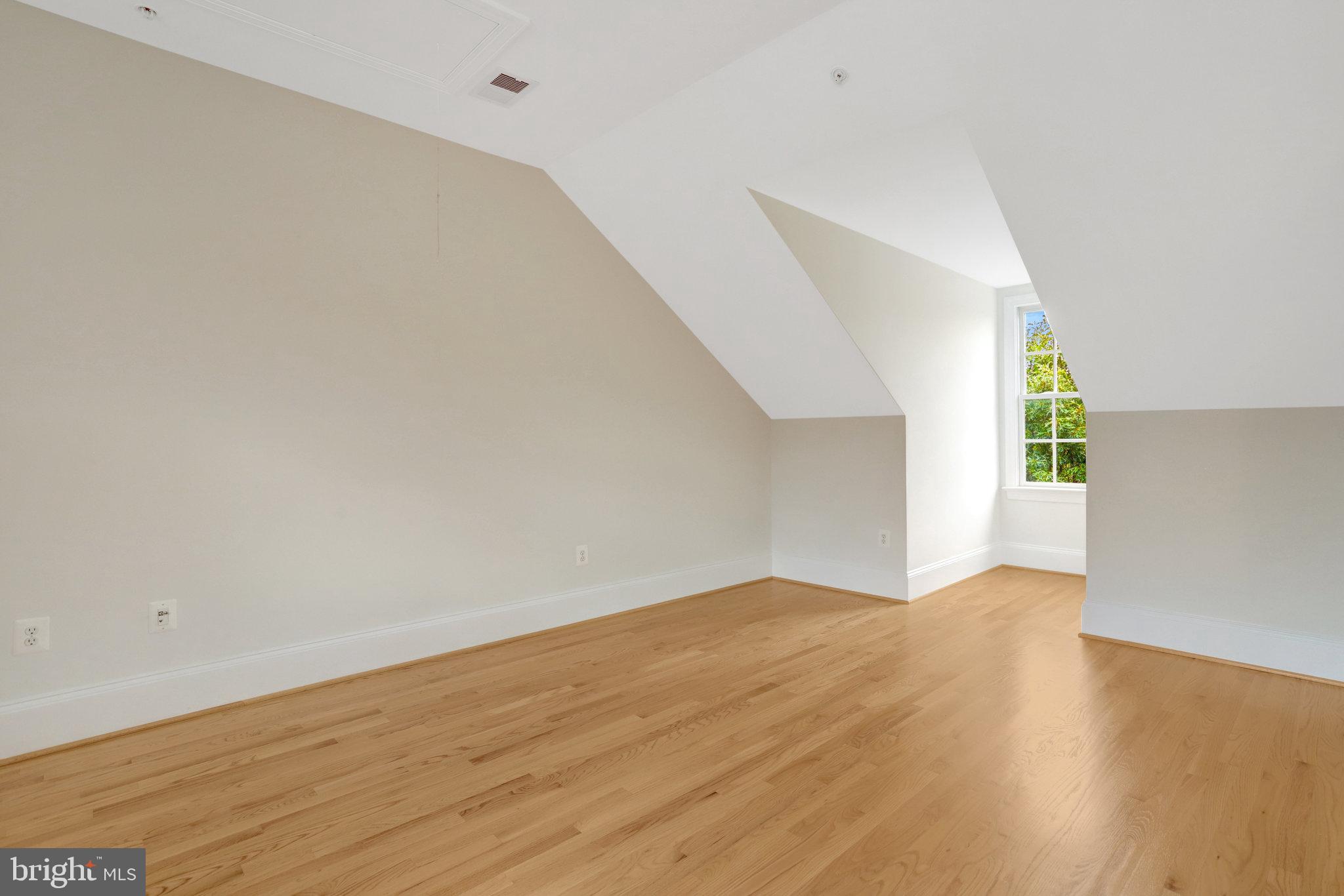1852 Carpenter Road Alexandria, VA 22314 - Photo 52 of 63 a view of an empty room with wooden floor and a window