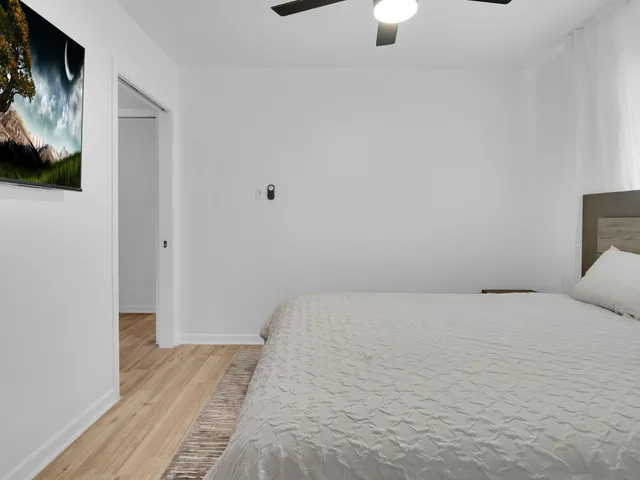 a bedroom with a bed and a flat screen tv