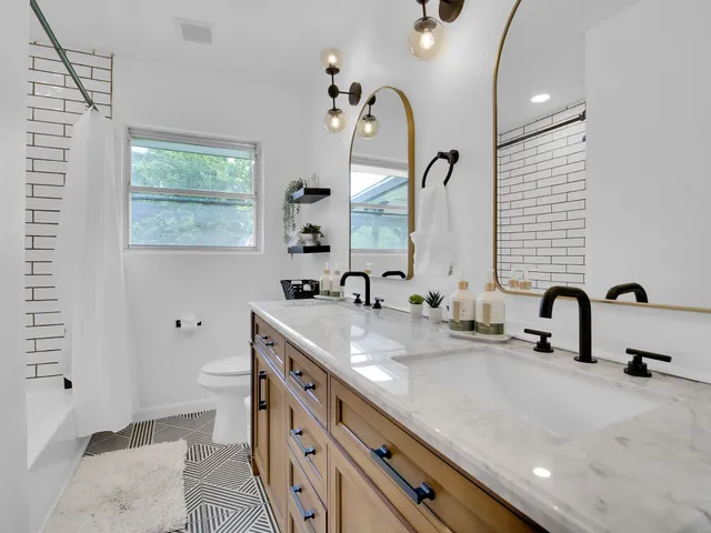 a bathroom with a double vanity sink mirror and double