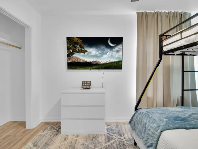 a view of hallway with wooden floor and stairs