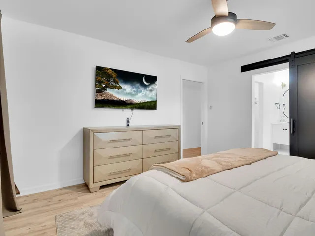 a bedroom with a bed and a flat screen tv
