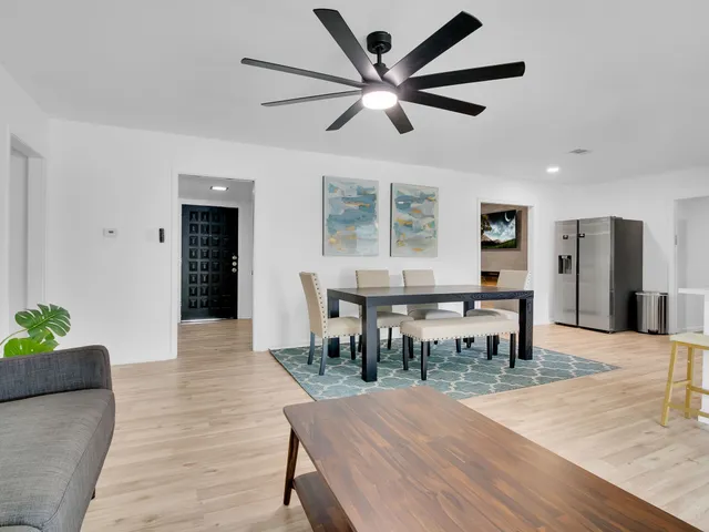 a view of a dining room with furniture and window