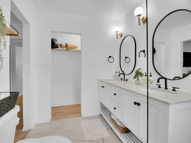 a bathroom with sinks mirror and vanity