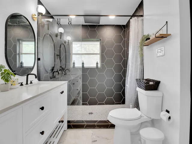 a bathroom with a toilet sink and mirror