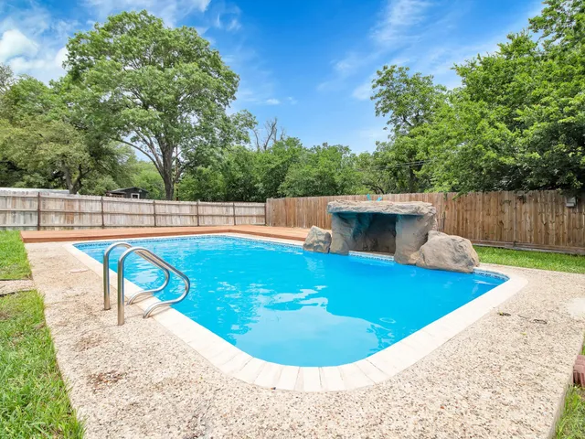 a view of a swimming pool with a patio
