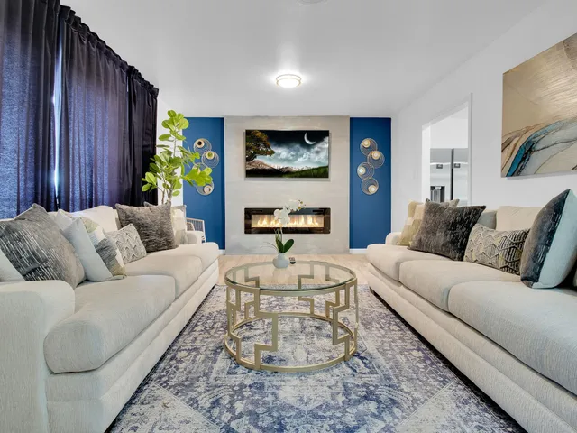 a living room with furniture and a painting