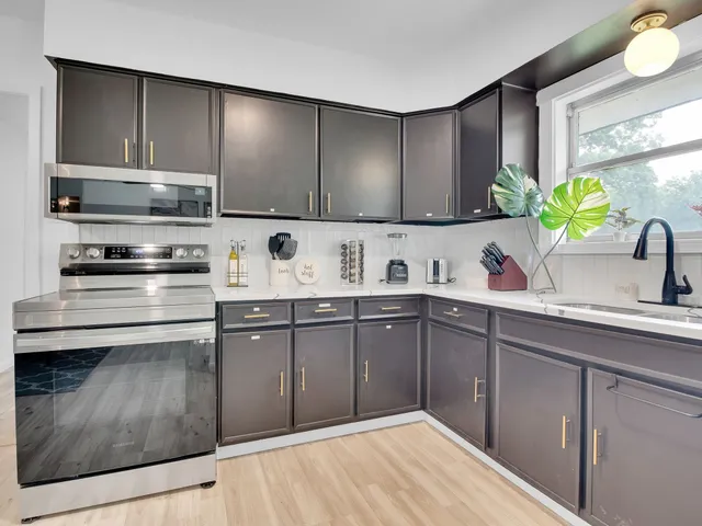 a kitchen with a sink cabinets and appliances