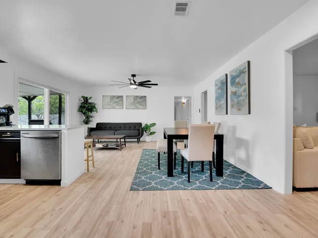 a view of a dining room with furniture and wooden floor
