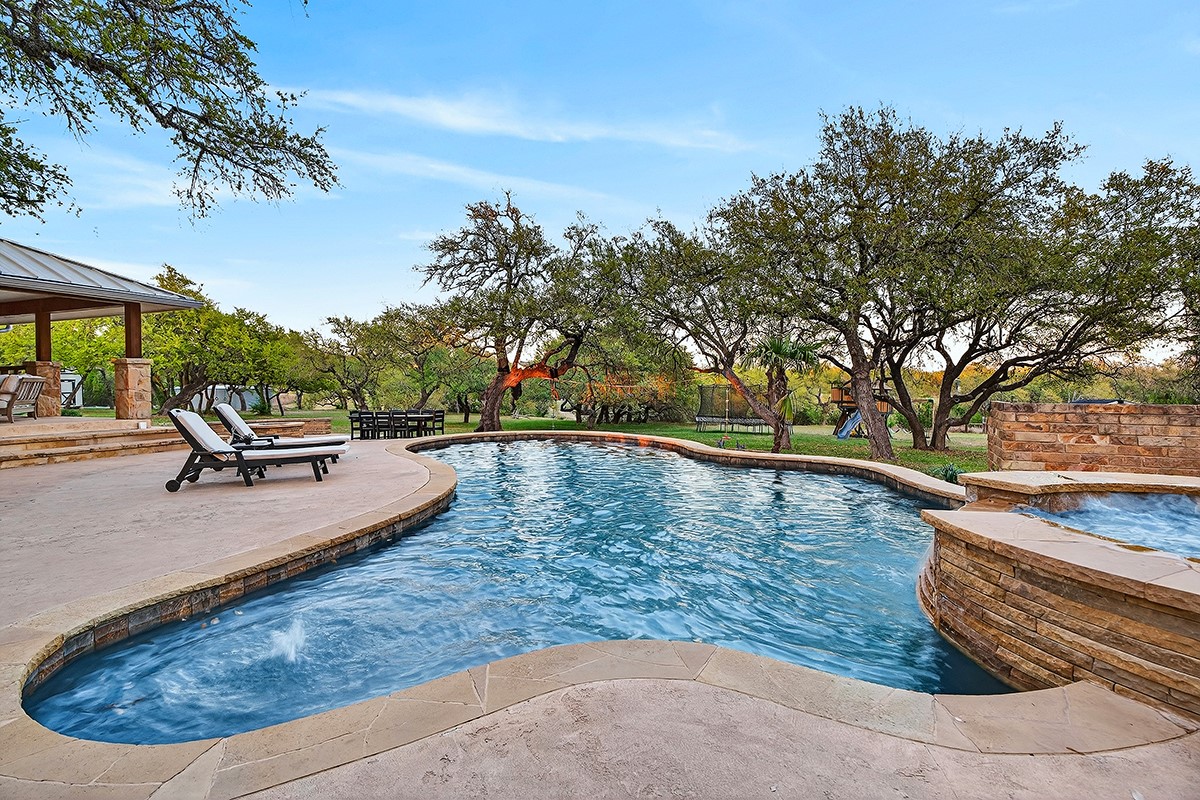 301 Medlin Creek Loop Dripping Springs, TX 78620 - Photo 4 of 40 a view of a swimming pool with an outdoor space