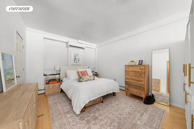 a bedroom with a bed and a view of kitchen