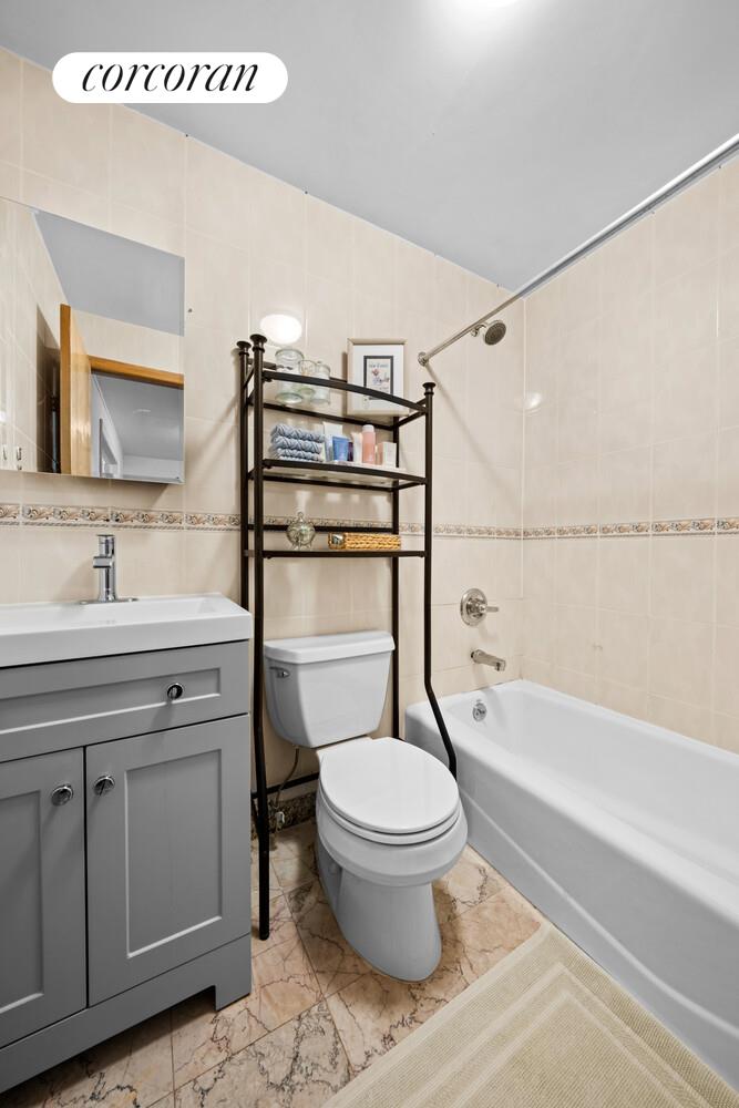 183 Duane Street Manhattan, NY 10013 - Photo 13 of 19 a bathroom with a granite countertop toilet sink and mirror