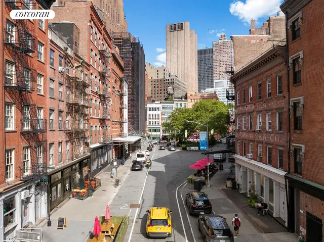 a view of buildings with cars