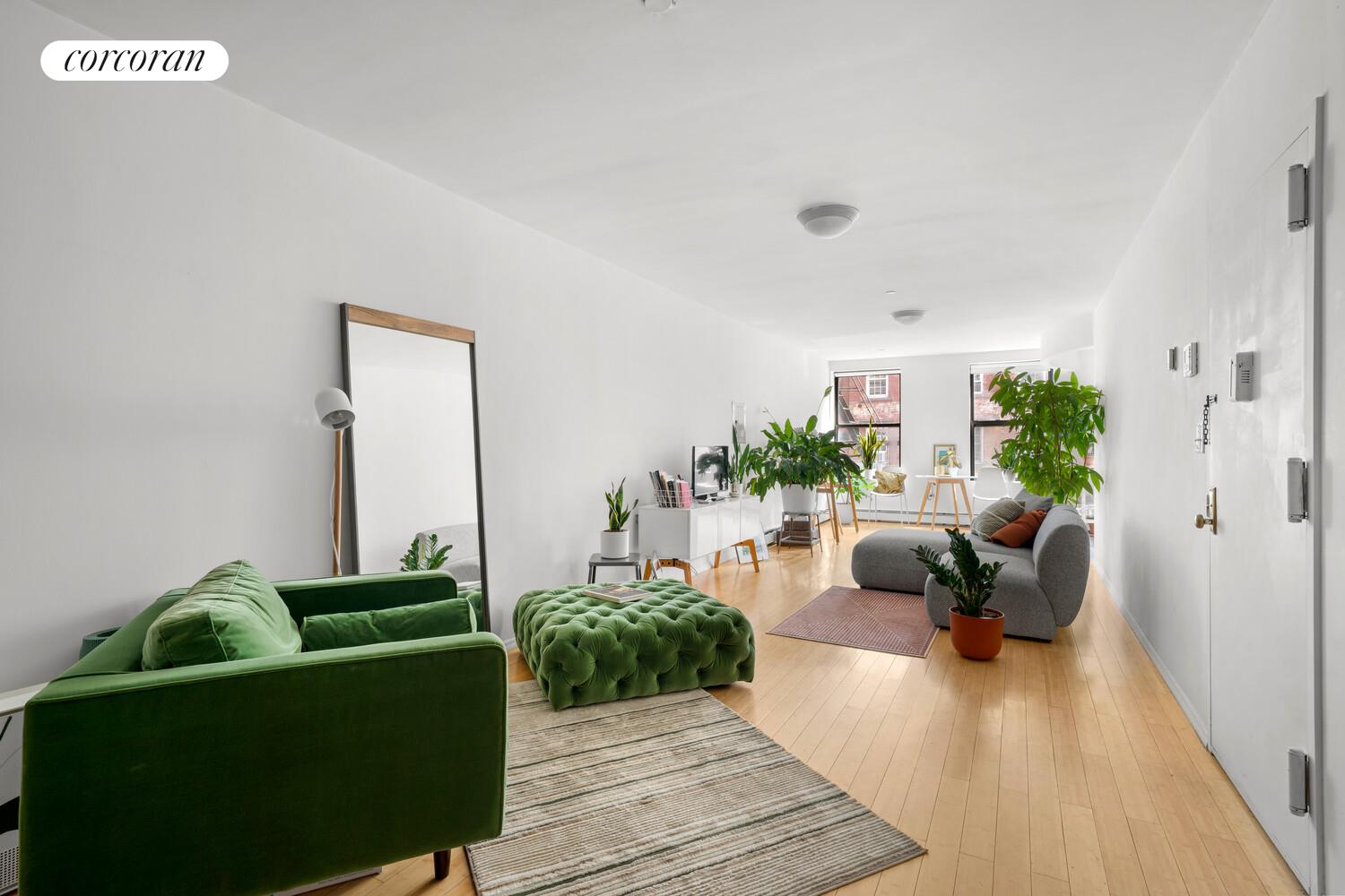 183 Duane Street Manhattan, NY 10013 - Photo 4 of 19 a living room with furniture and a wooden floor