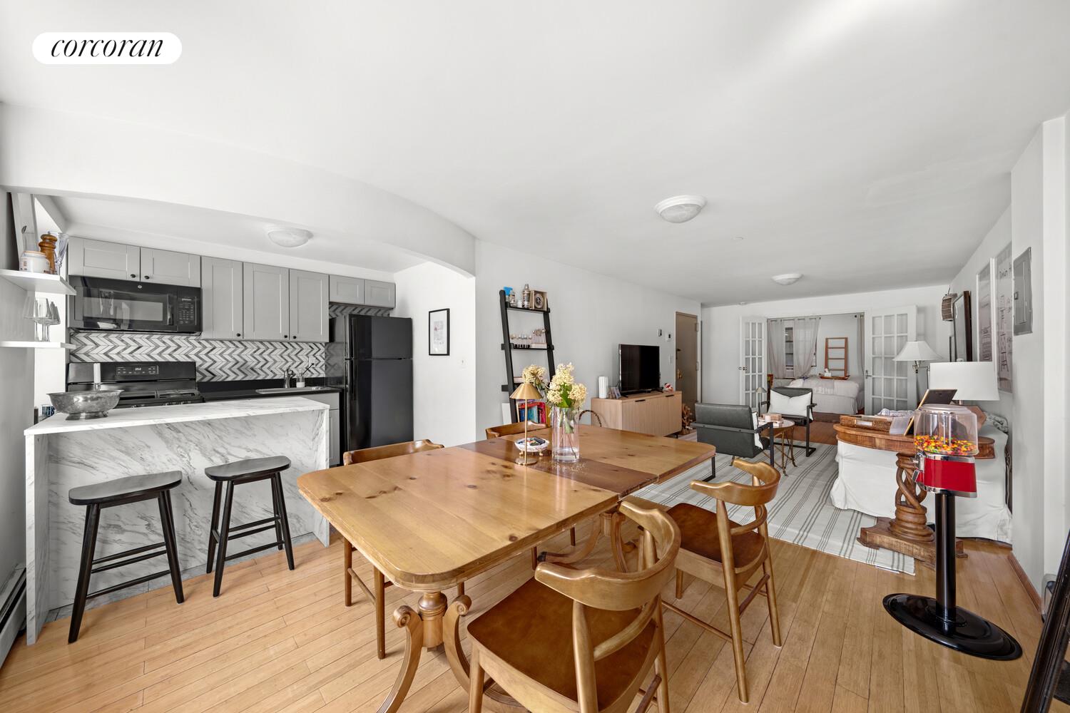 183 Duane Street Manhattan, NY 10013 - Photo 7 of 19 a view of a dining room with furniture and wooden floor
