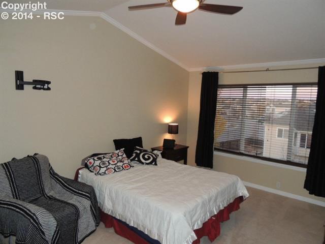 6797 Akron Road Colorado Springs, CO 80923 - Photo 14 of 23 Large Master Suite with Four Piece On-Suite and Vaulted Volume Ceilings Graciously Accented by Crown Molding! Allow the Twinkling City Light to add the Perfect Ambiance to Restful Dreaming!