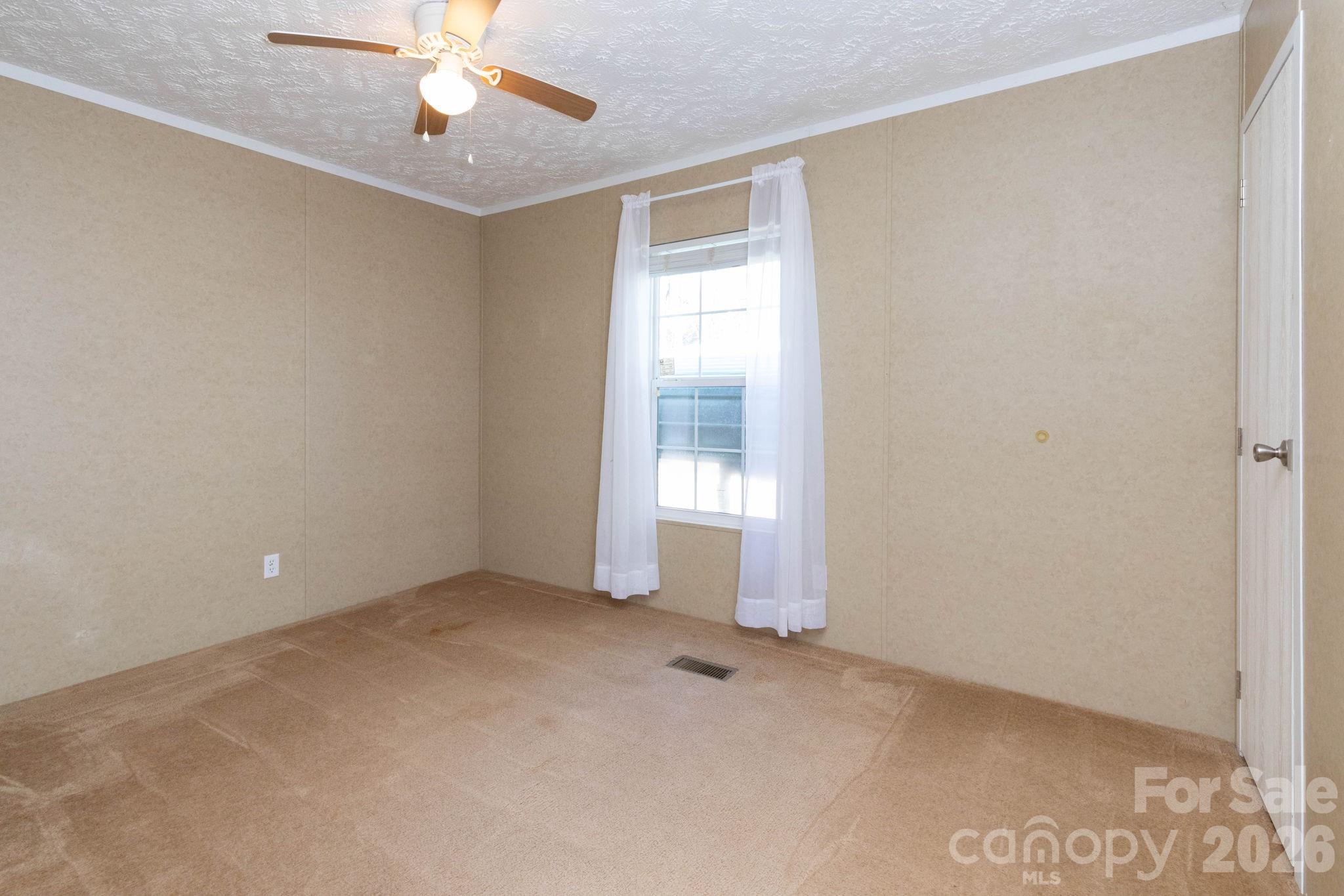87 Hickory Nut Trace Old Fort, NC 28762 - Photo 11 of 26 an empty room with chandelier fan
