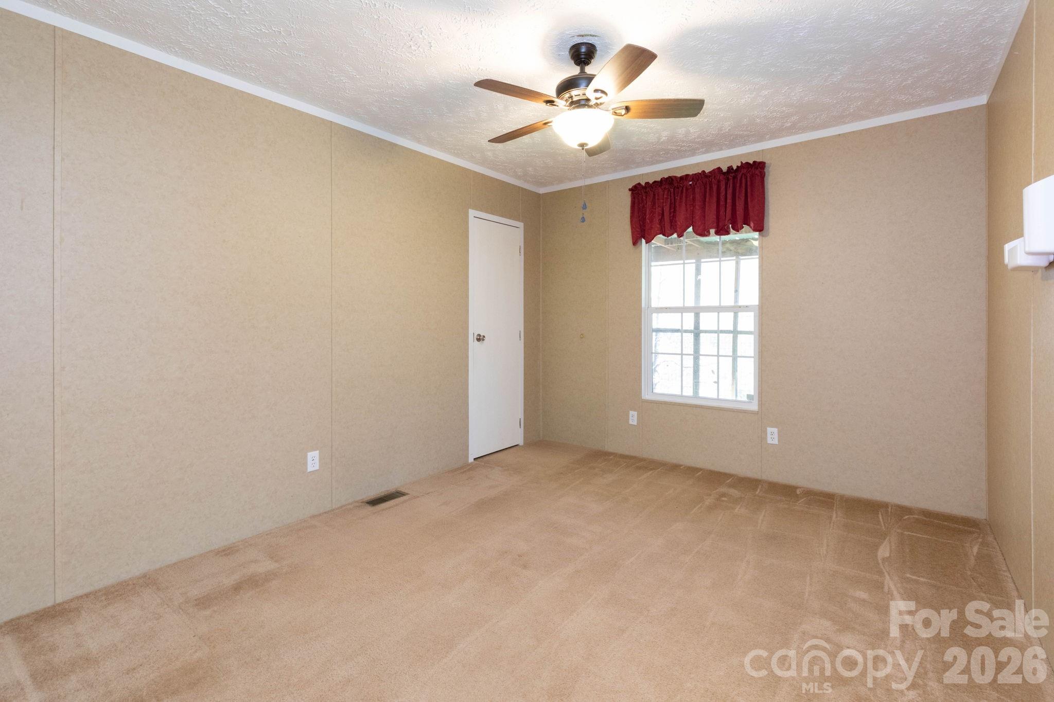 87 Hickory Nut Trace Old Fort, NC 28762 - Photo 12 of 26 an empty room with windows and ceiling fan