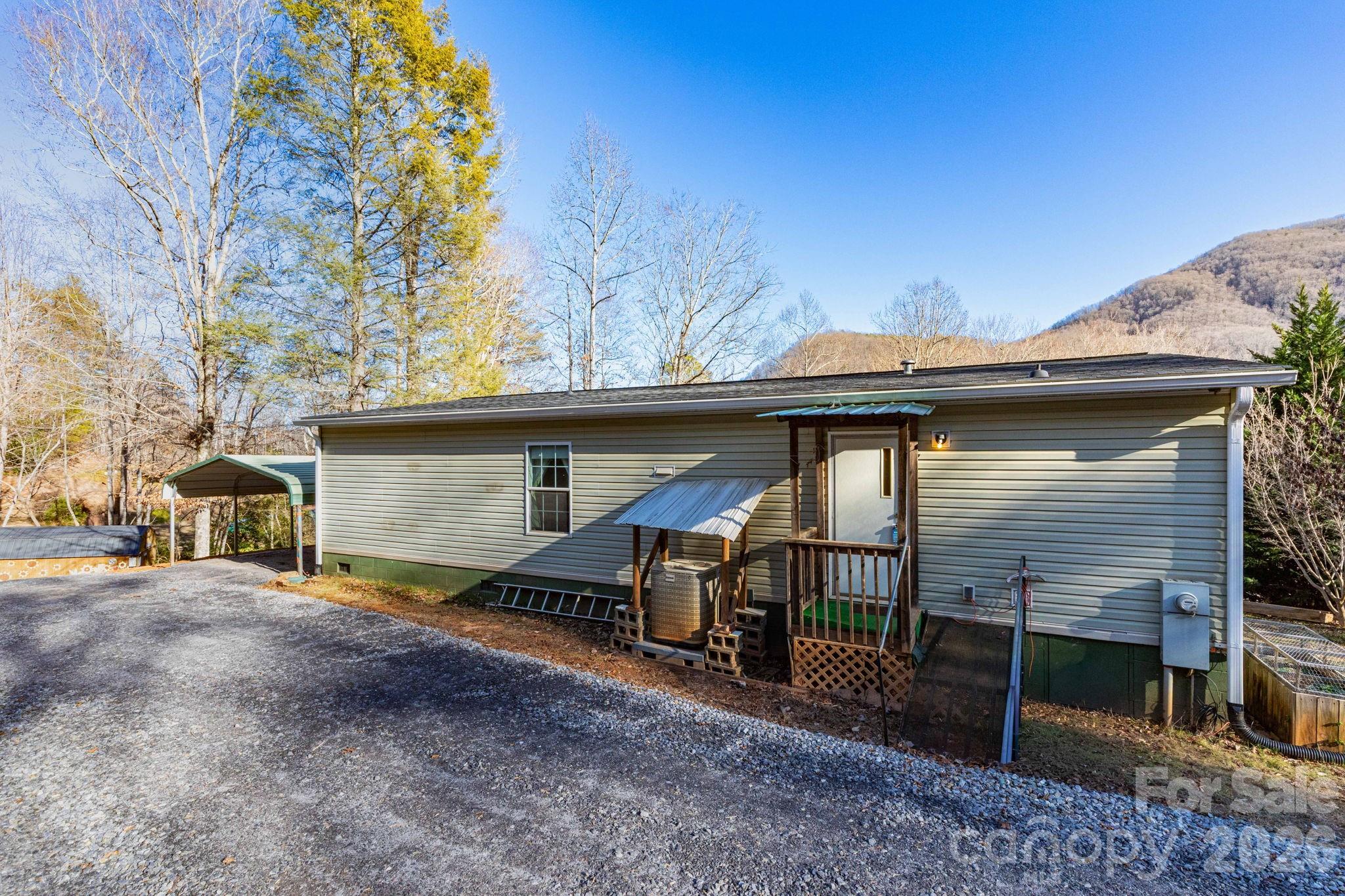 87 Hickory Nut Trace Old Fort, NC 28762 - Photo 19 of 26 a view of a house with a patio and a yard