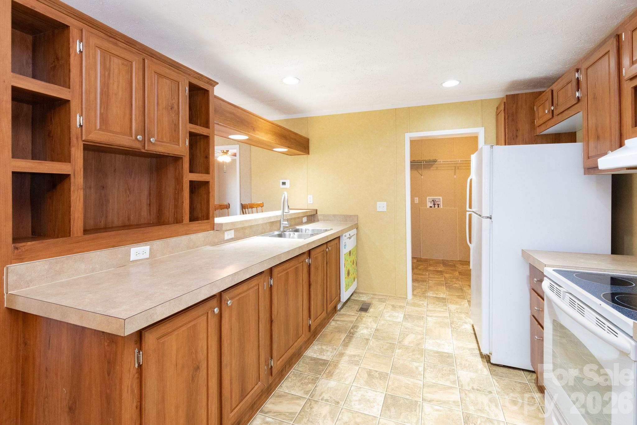 87 Hickory Nut Trace Old Fort, NC 28762 - Photo 9 of 26 a kitchen with kitchen island granite countertop a sink cabinets and stainless steel appliances