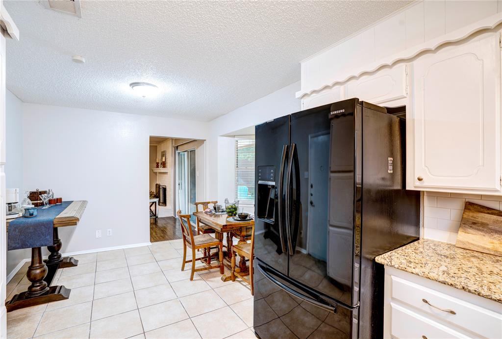 6028 Ridgecrest Drive Watauga, TX 76148 - Photo 13 of 40 a view of kitchen with refrigerator and dining table