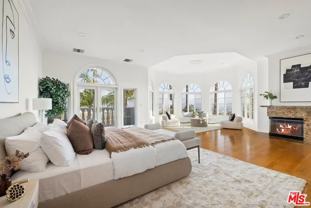a living room with fireplace furniture and a large window
