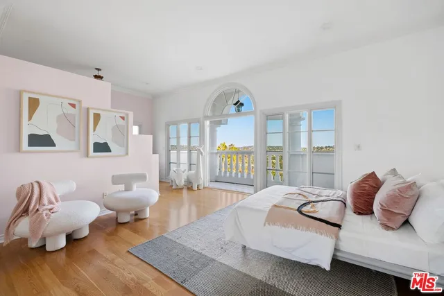 a spacious bedroom with a bed couch and a window