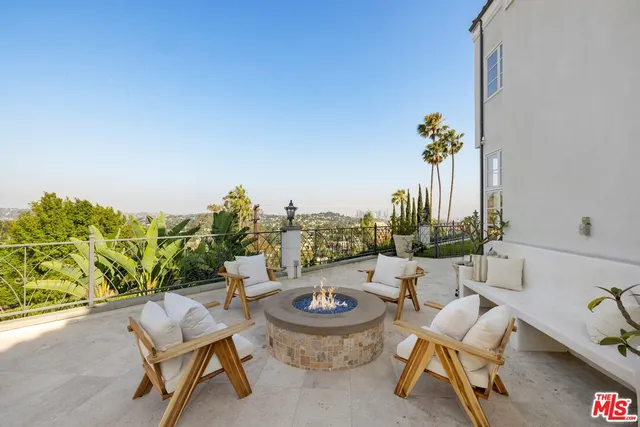 a view of roof deck with couches and city view