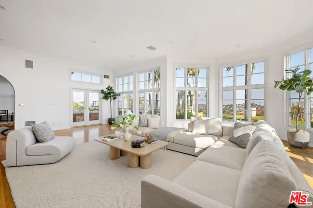 a living room with furniture and large windows