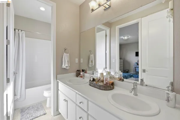a bathroom with double vanity sinks and a mirror