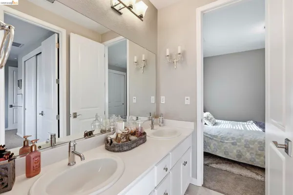 a bathroom with double vanity sinks and a mirror