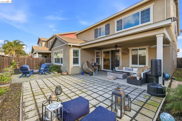 a view of a house with backyard porch and sitting area
