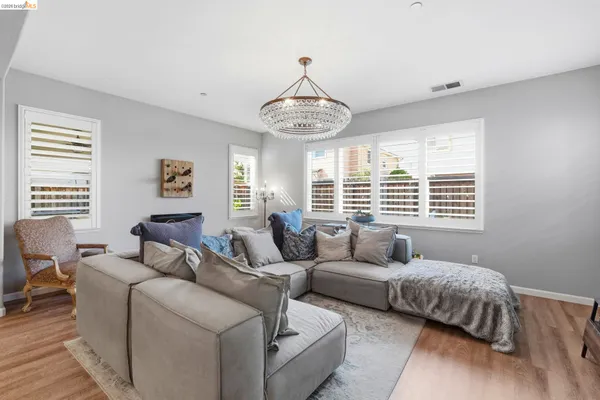 a living room with furniture and a chandelier