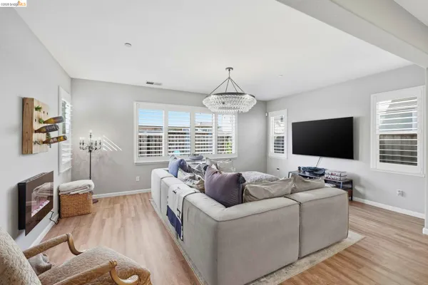 a living room with furniture wooden floor and a flat screen tv