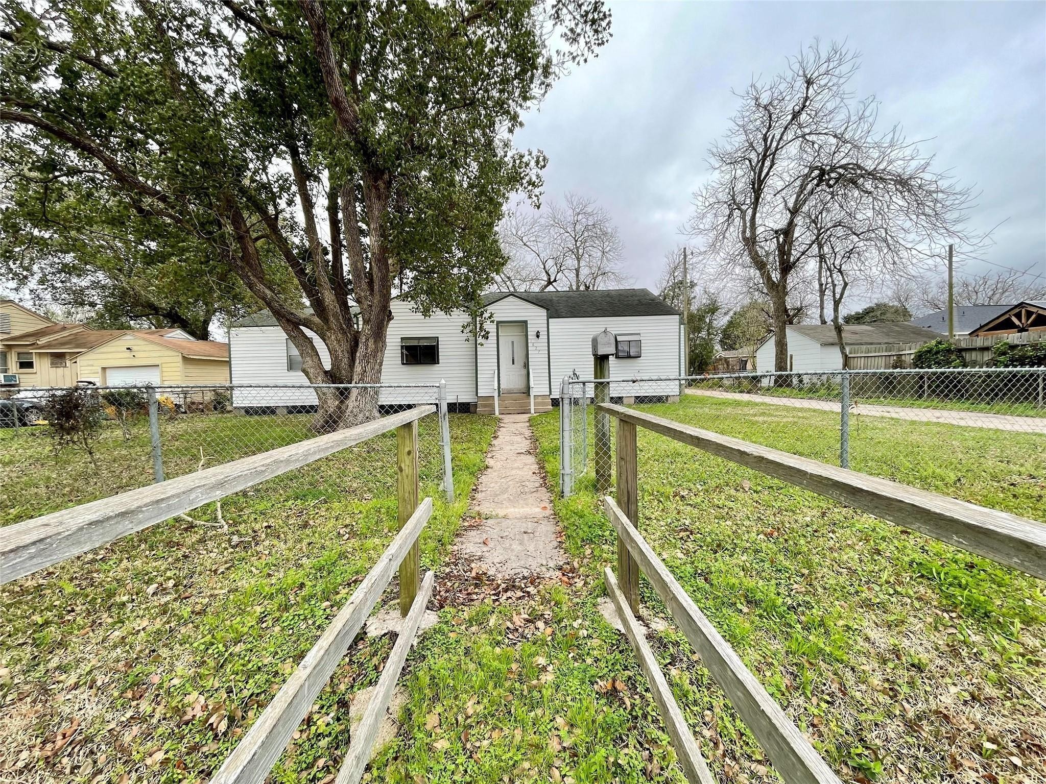 1827 Neuman La Marque, TX 77568 - Photo 1 of 24 a view of swimming pool with a garden and trees