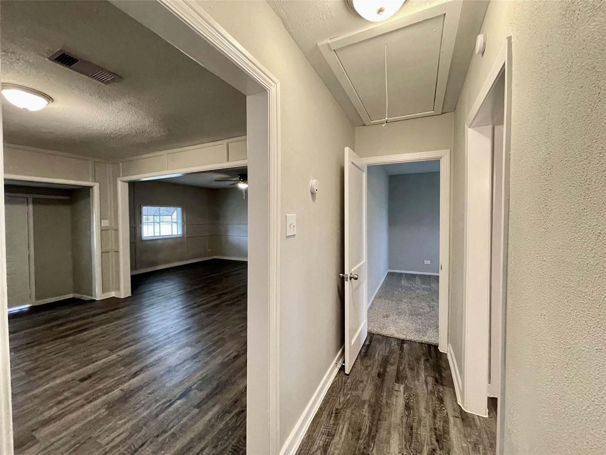 1827 Neuman La Marque, TX 77568 - Photo 12 of 24 a view of a hallway view with wooden floor and staircase