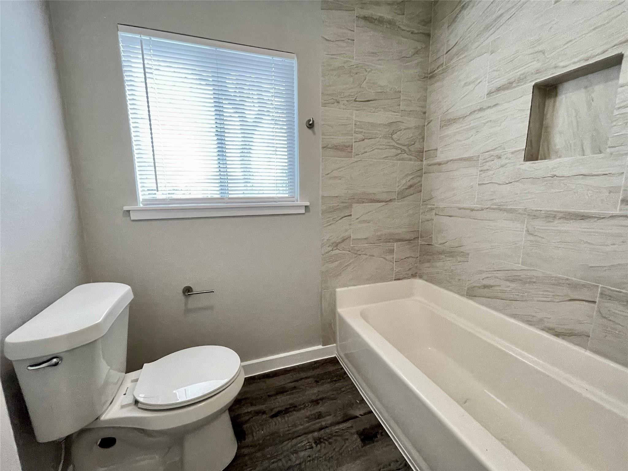 1827 Neuman La Marque, TX 77568 - Photo 17 of 24 a bathroom with a sink and a toilet