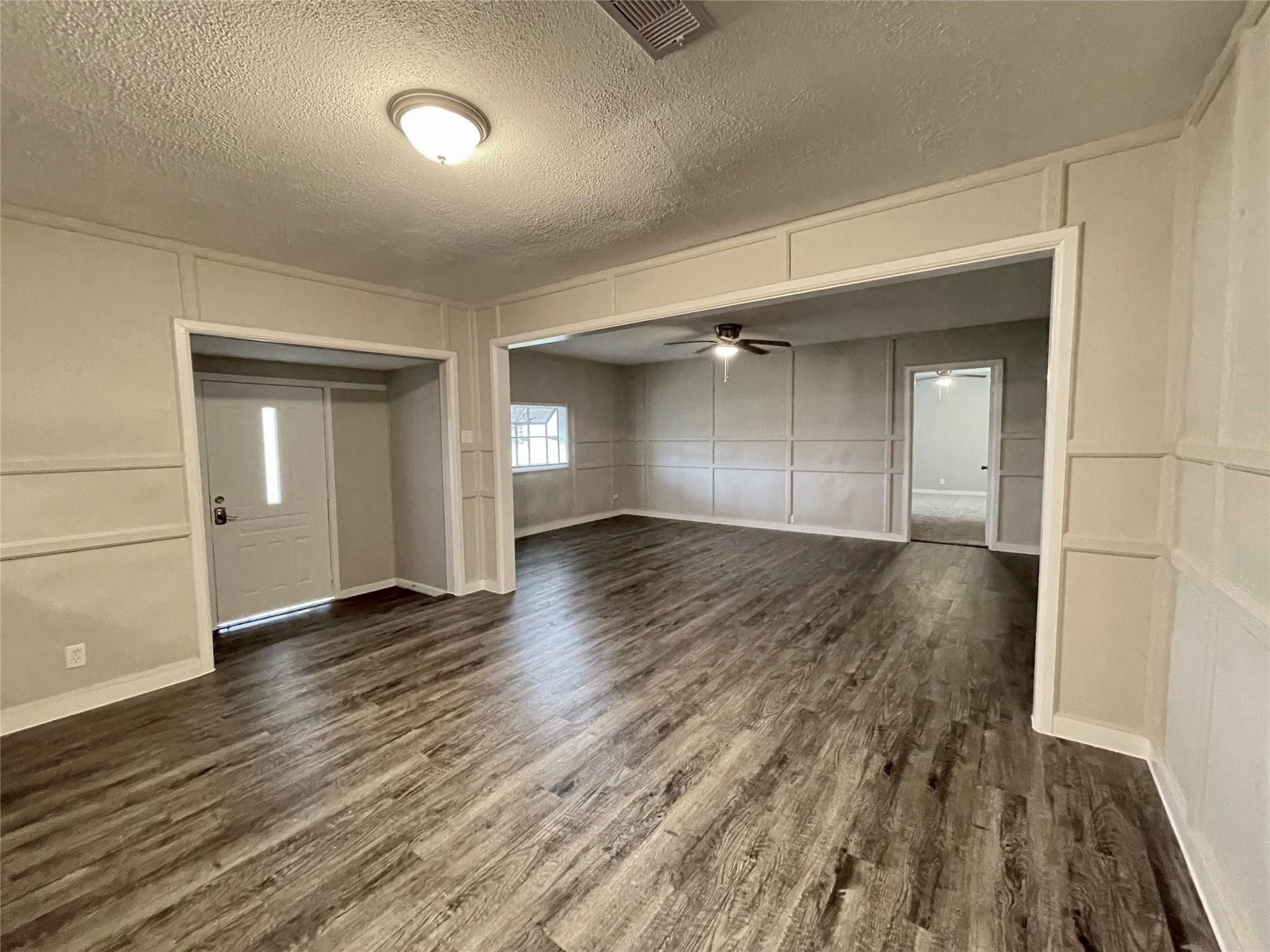 1827 Neuman La Marque, TX 77568 - Photo 8 of 24 wooden floor in an empty room with a window