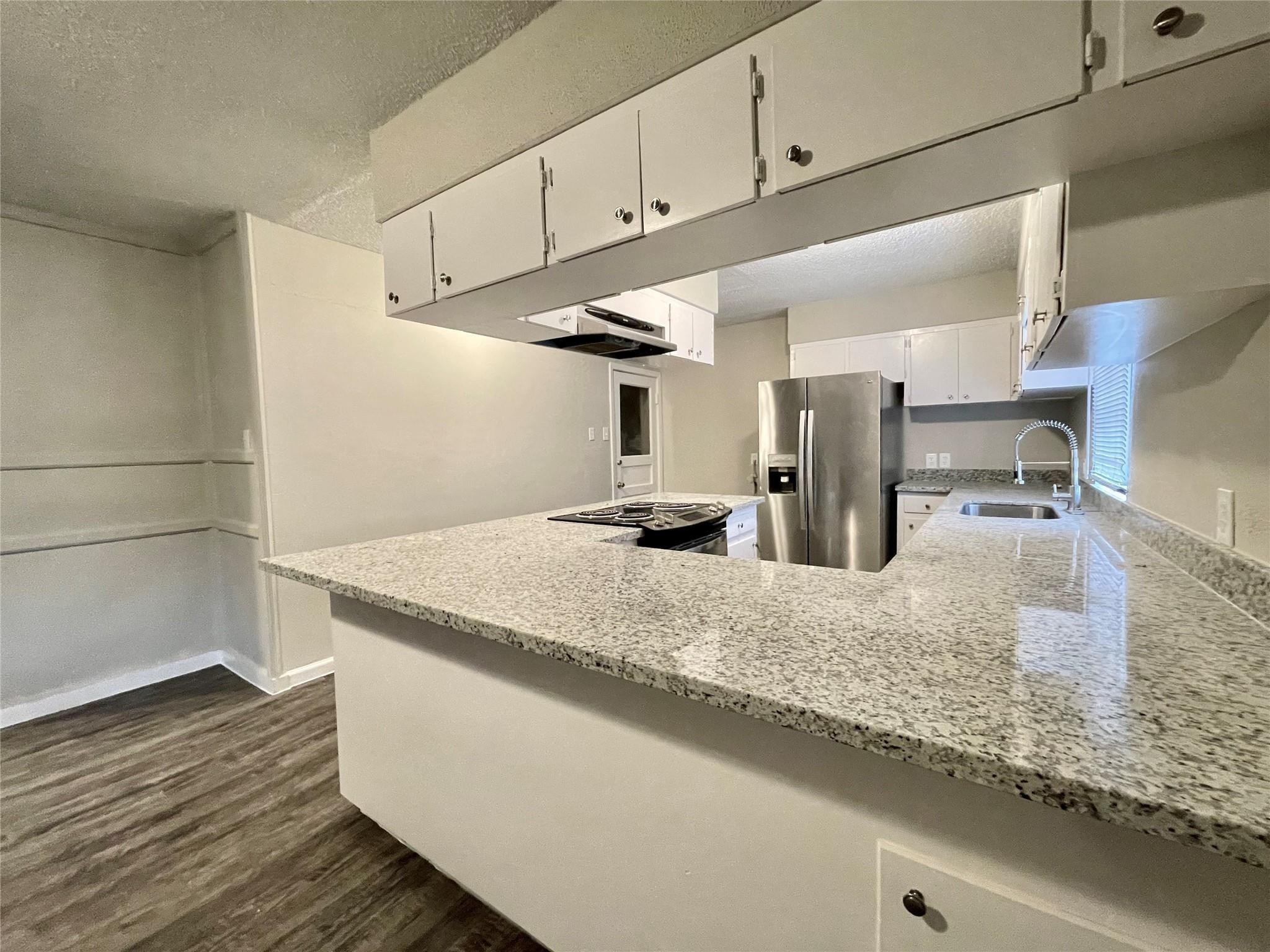 1827 Neuman La Marque, TX 77568 - Photo 10 of 24 a view of a kitchen counter space with wooden floor