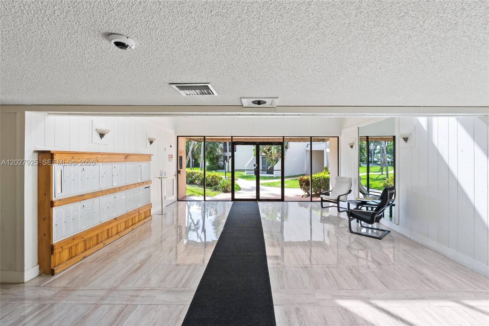 301 Racquet Club Road, Unit 103 Weston, FL 33326 - Photo 4 of 20 a living room with furniture and a large window