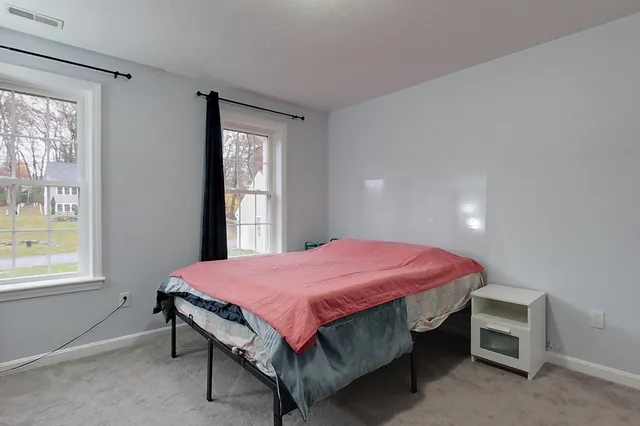 a bedroom with a bed and window