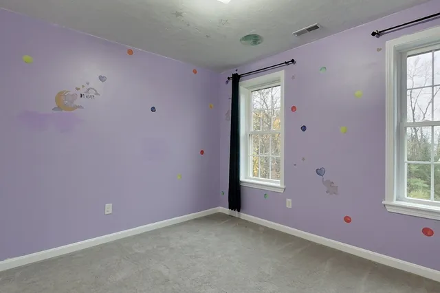 an empty room with windows and closet